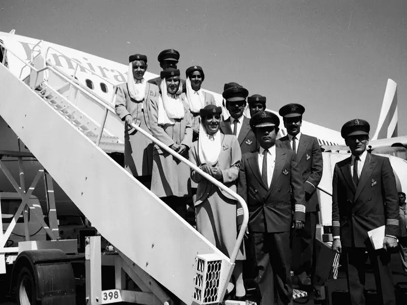 A black and white photo of Emirates cabin crew before embarking on their first flight.
